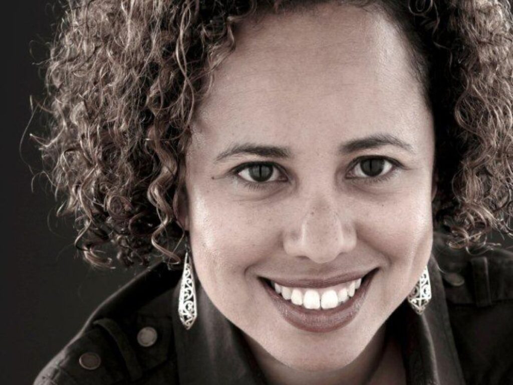 A headshot of Sol Flores, smiling