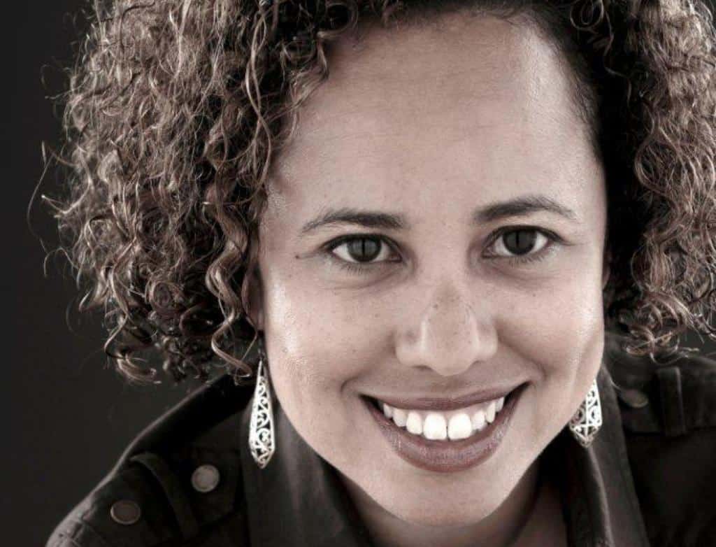 A headshot of Sol Flores, smiling