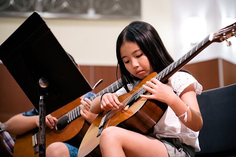 student in guitar class