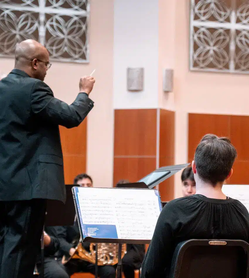 faculty instructor conducting a performance