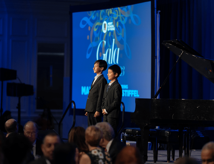 Simon Cegys and Robert Tang take a bow in front of the piano.