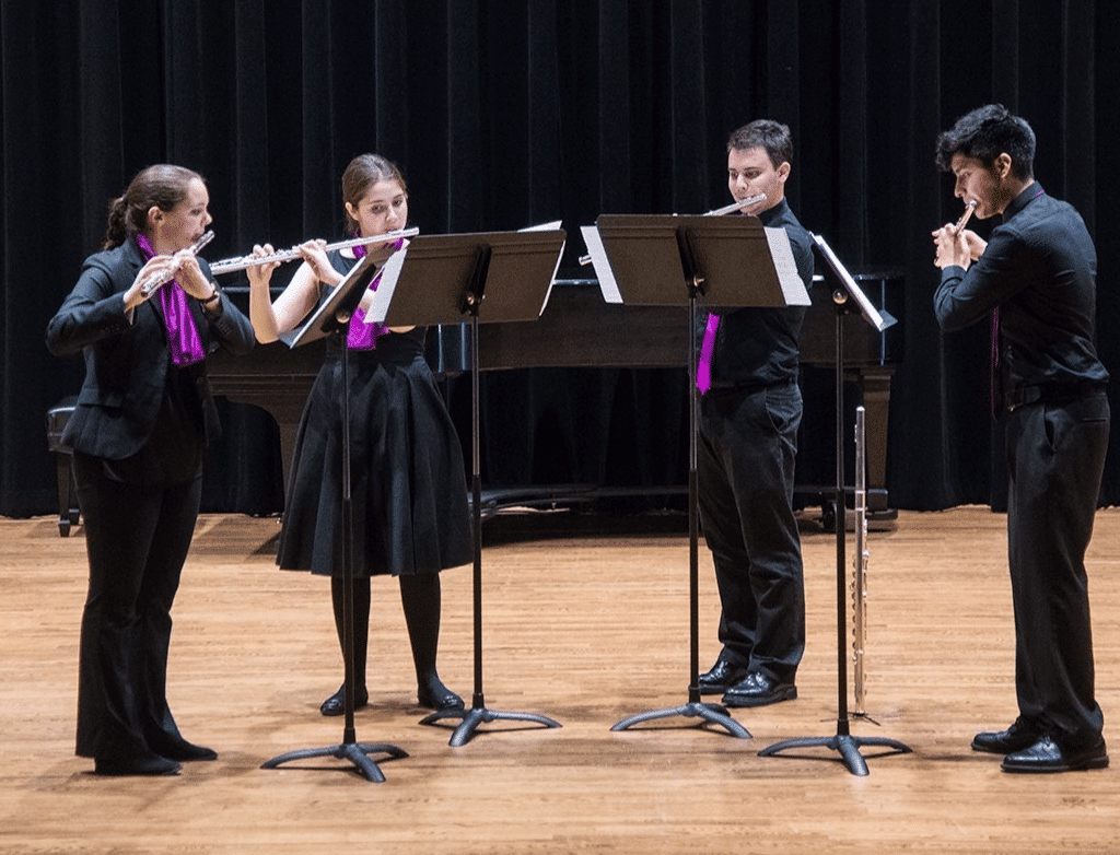 The 2017-2018 Purple Hippopotami perform together on stage.