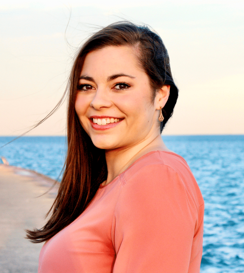 A photo of Lillia Woolschlager with the beach in the background.