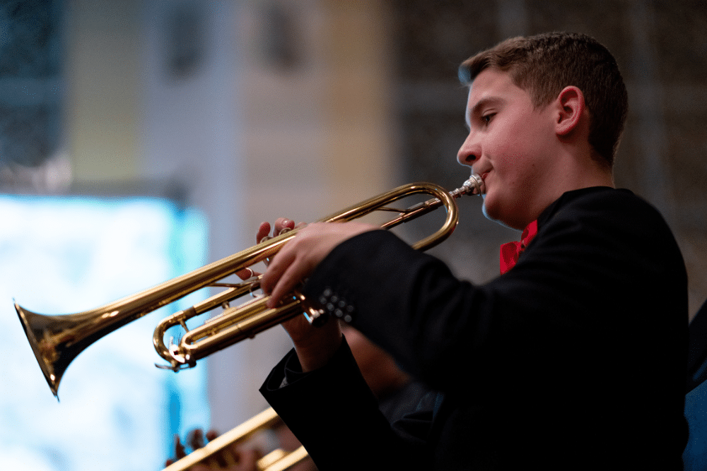 A young student plays trumpet.