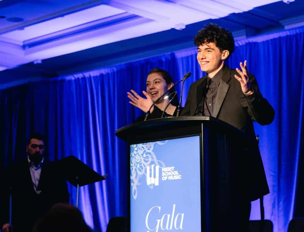 Two students smiling at the podium