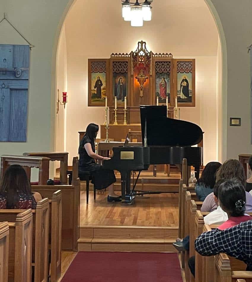 Nicole Yu plays piano in a church