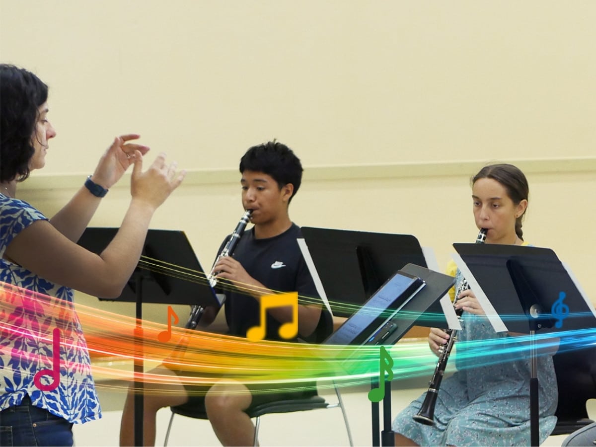 A teacher conducts as two students play clarinet