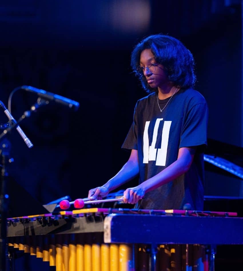 A teen plays vibraphone onstage