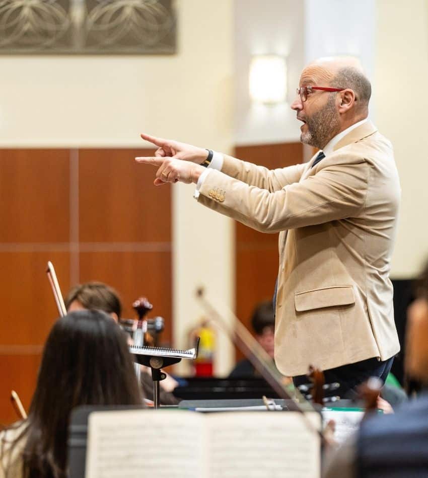 Mazzola conducts the orchestra onstage