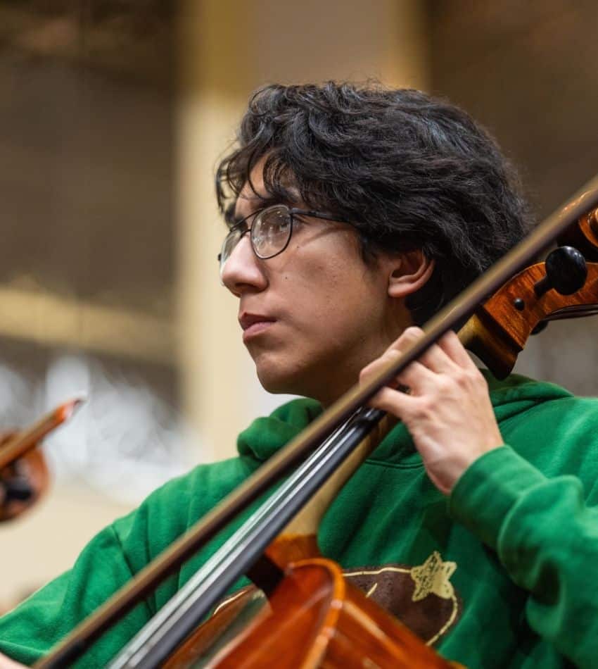 A teen plays cello