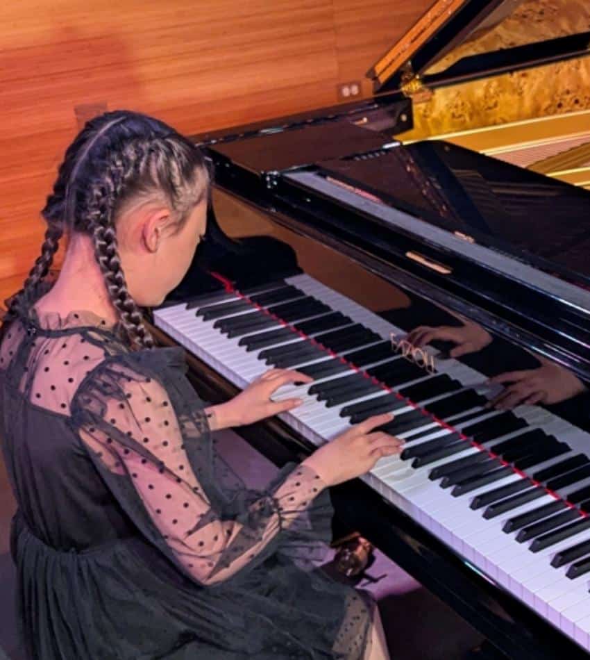 A student plays piano.