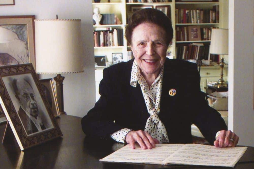 Emma Endres-Kountz stands posed with sheet music in front of her.